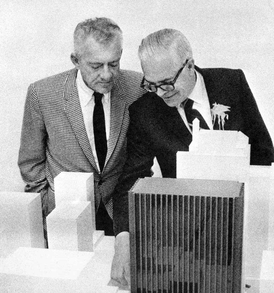 Black and white image of Howard K. Smith, HKS's founder, working on a design model on a table